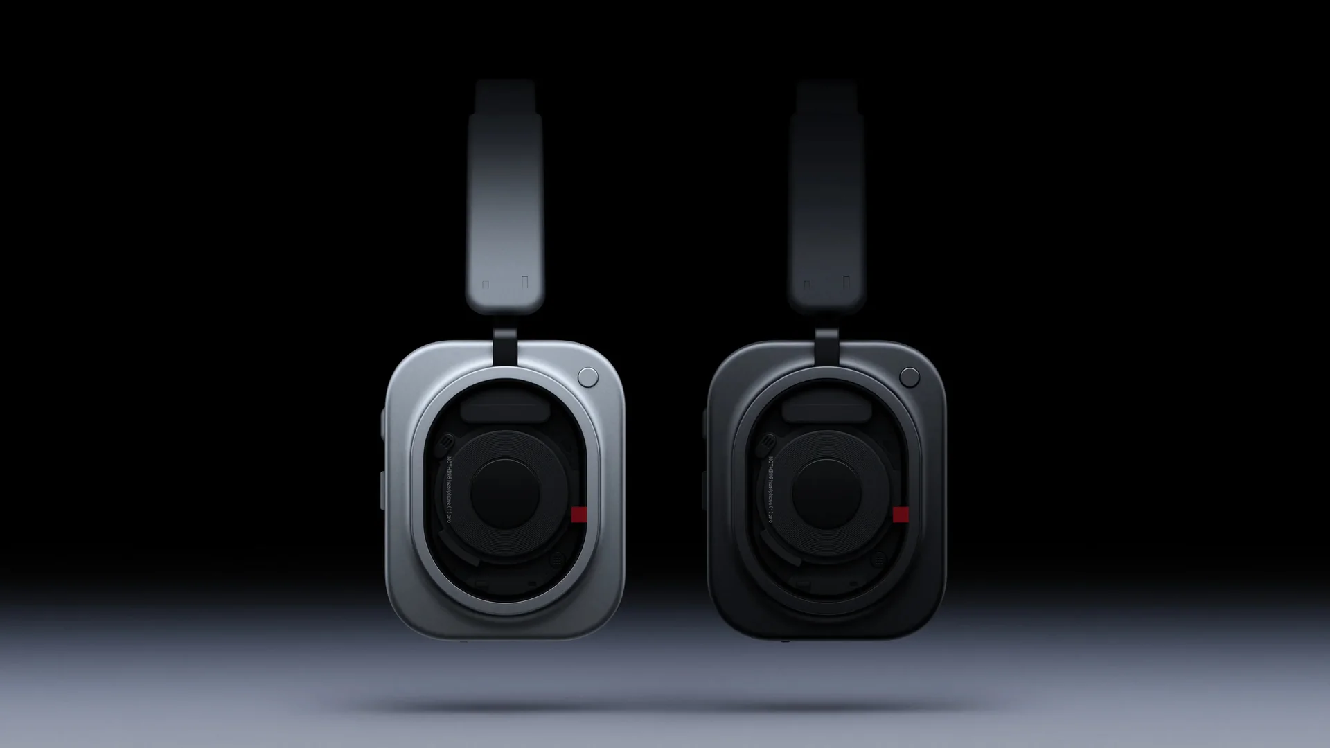 Two Headphone (1) Pro units, one white and one black, seen from the front on a dark background